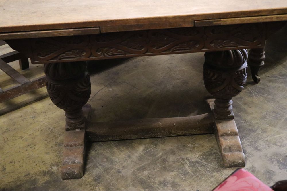 An Elizabethan style oak draw leaf extending dining table, 210cm extended width 80cm height 75cm